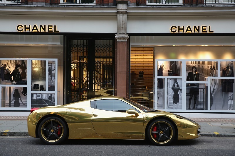 A gold Ferrari sits outside Chanel on Sloane Street in London