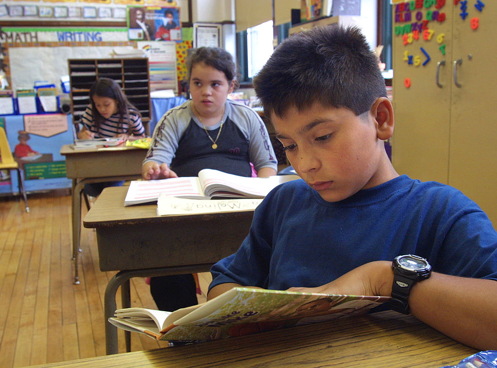 Students reading books in a classroom