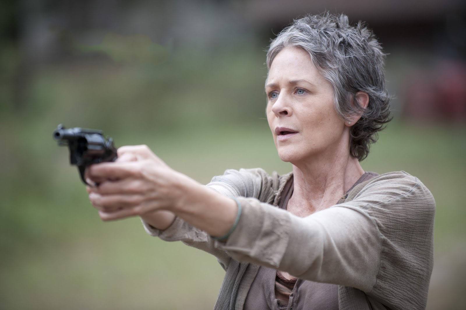 Carol holding a gun in a scene from 'The Walking Dead' episode 'The Grove'