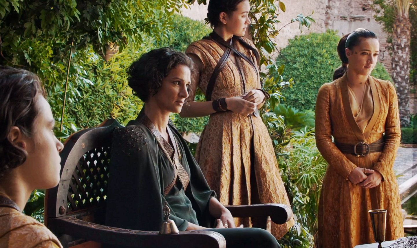 Ellaria Sand sits in her chair, surrounded by her supporters on a nice day in Game of Thrones