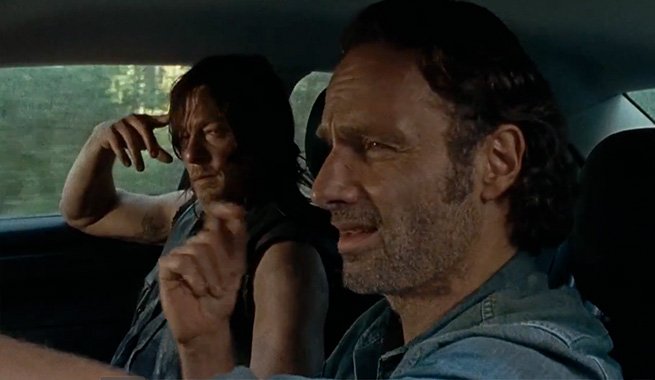 Daryl looks annoyed as Rick snaps along to a song on the car stereo in a scene from 'The Walking Dead' episode 'The Next World'