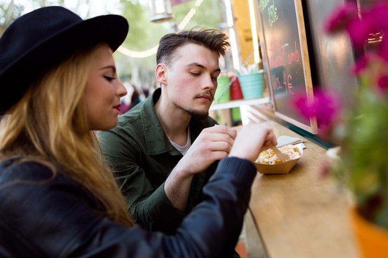 young couple at a food truck counter