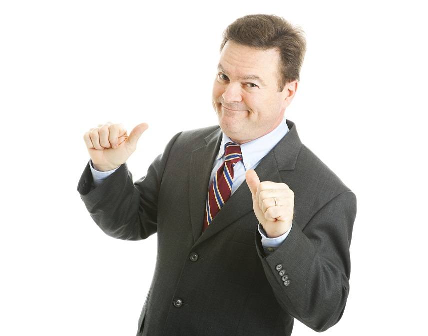 businessman points to himself with both thumbs