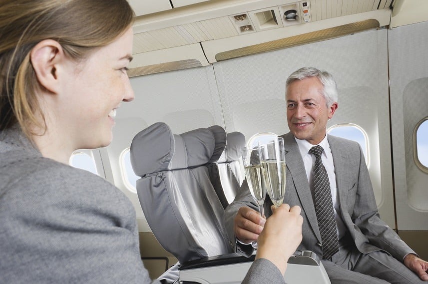toasting with champagne business class airplane cabin