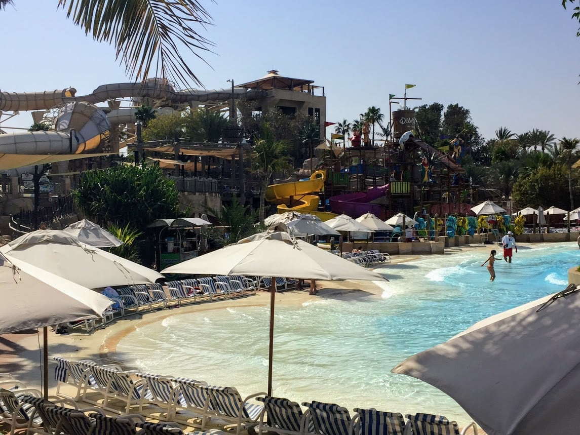 hotel waterpark with beach area, watersliders, and a splash park