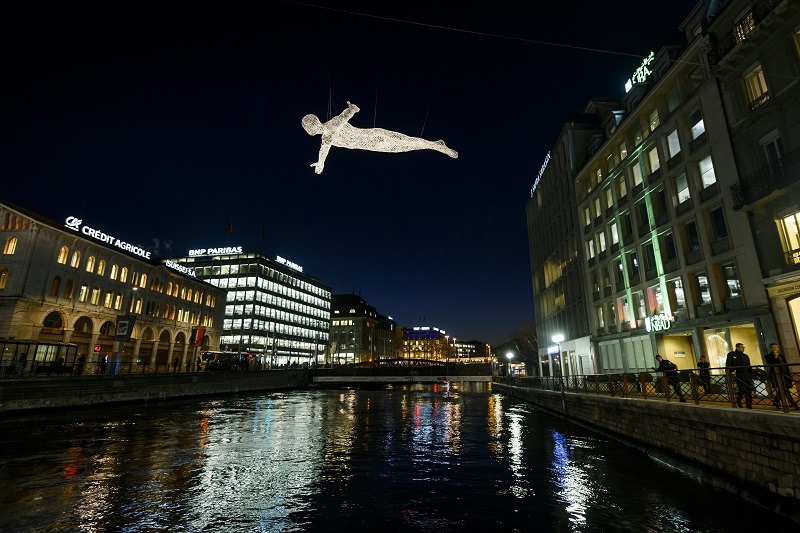 One of "The Travellers" created by French artist Cedric Le Borgne appears to fly above the Rhone in Geneva -- one of the world's most expensive cities