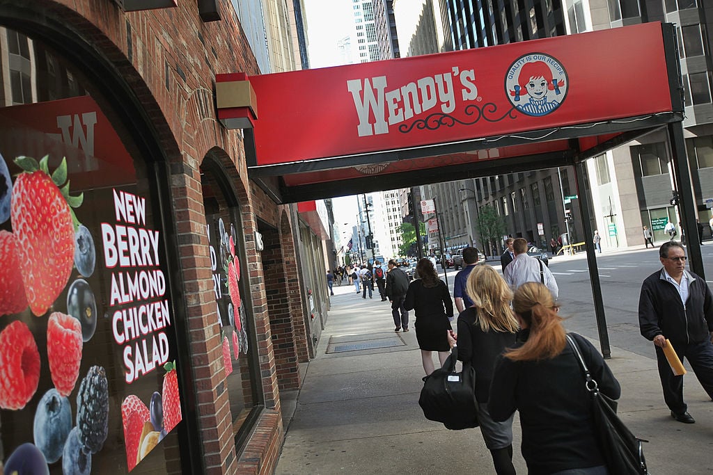 Pedestrians walk past a Wendy's restaurant
