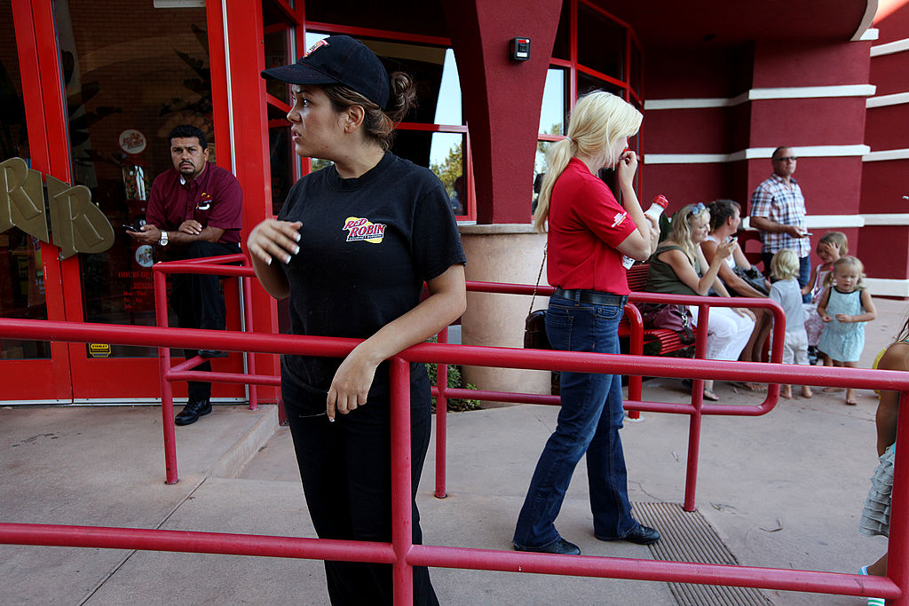 Workers stand outside of a Red Robin Restaurant