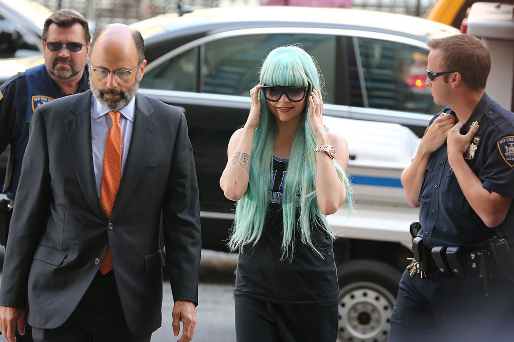 Amanda Bynes in a blue wig and sunglasses walking in New York