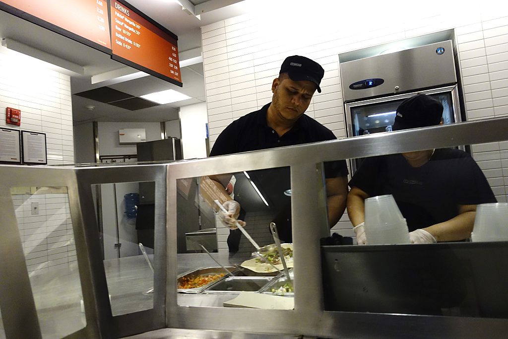 Chipotle employee prepares food in Manhattan