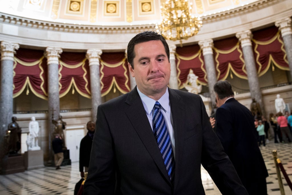 Representative Devin Nunes walks in an ornate chamber in Congress