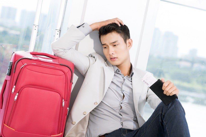 young businessman with luggage in trouble