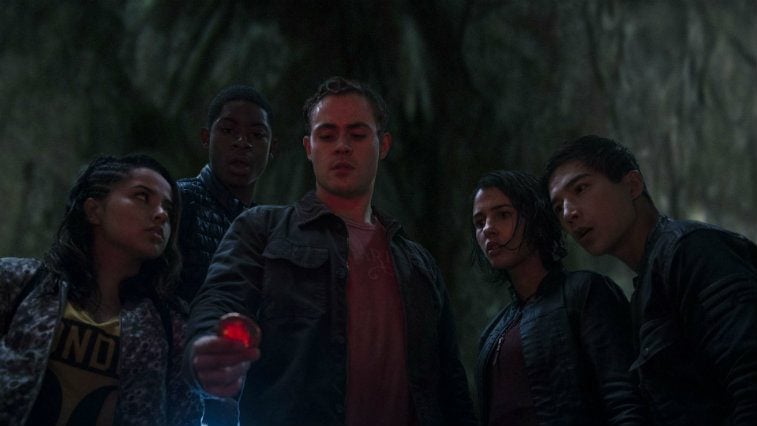 Power Rangers all looking at a red object