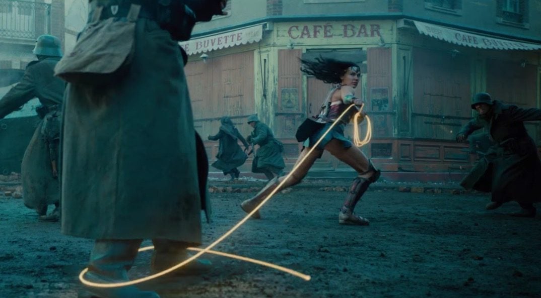 Wonder Woman wields the Lasso of Truth as soldiers run
