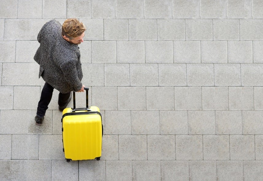 man walking with suitcase