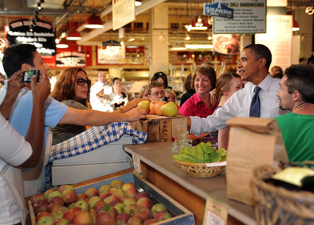 Barack Obama greets customers at a grocery store.