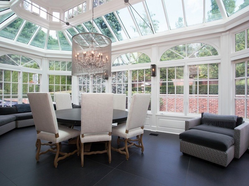 The living room of Alicia Keys' mansion shows floor to ceiling windows, a vaulted ceiling and a modern chandelier.