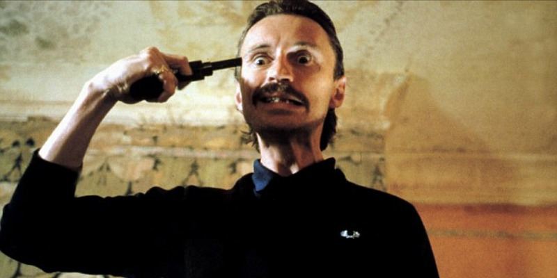 Begbie holds a gun to his head in Trainspotting.