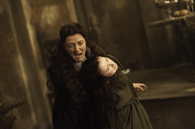 Catelyn Stark screams as she holds a knife to the throat of Walder Frey's wife in a scene from 'The Rains of Castamere.'