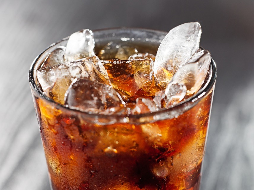 Glass of cola drink with ice, shot close up with selective focus.