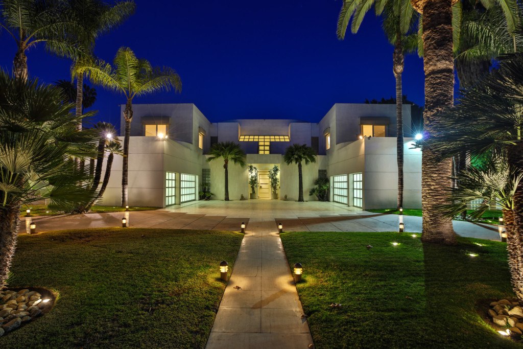 Jackie Collins' modern estate in the Hollywood Hills is surrounded by palm trees.