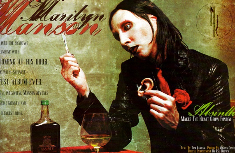 Marilyn Manson holding a cut off ear next to a glass and bottle of Mansinthe