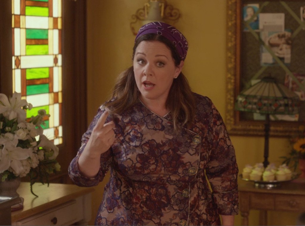 A woman wearing a bandana and a smock