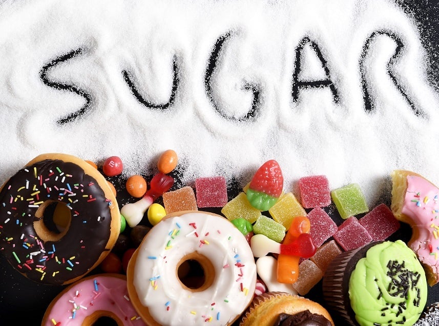 Doughnuts and candy with "sugar" written in sugar