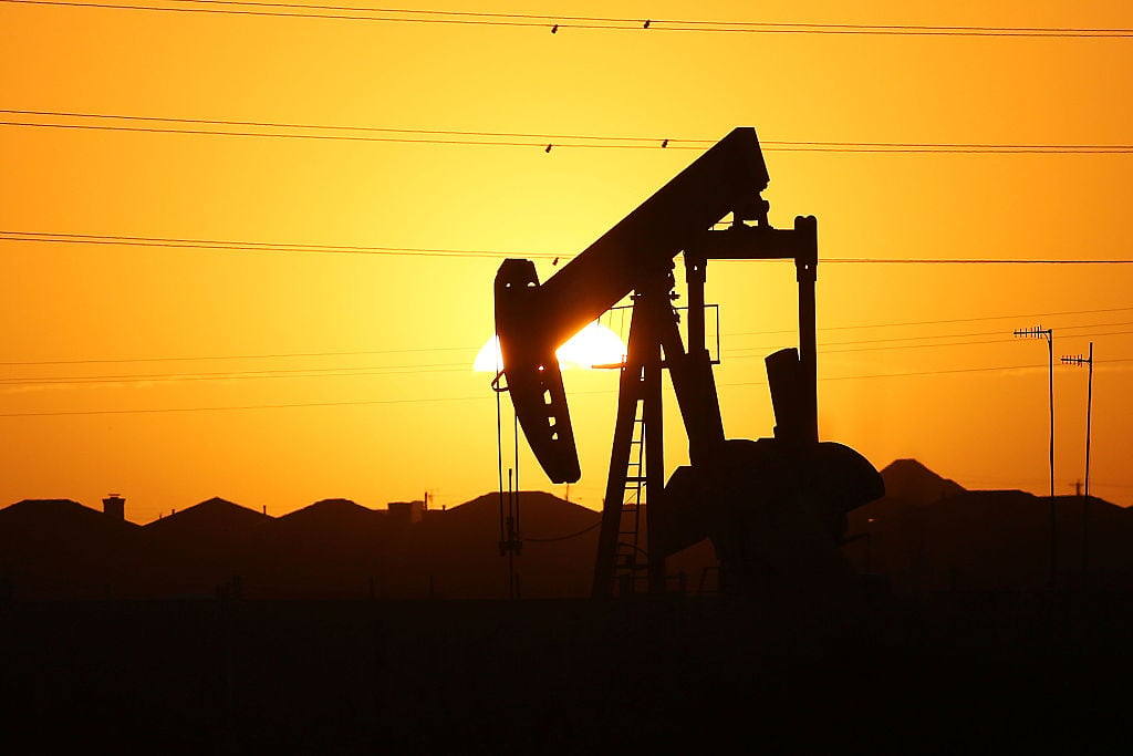 A pumpjack sits on the outskirts of town at dawn in the Permian Basin oil field