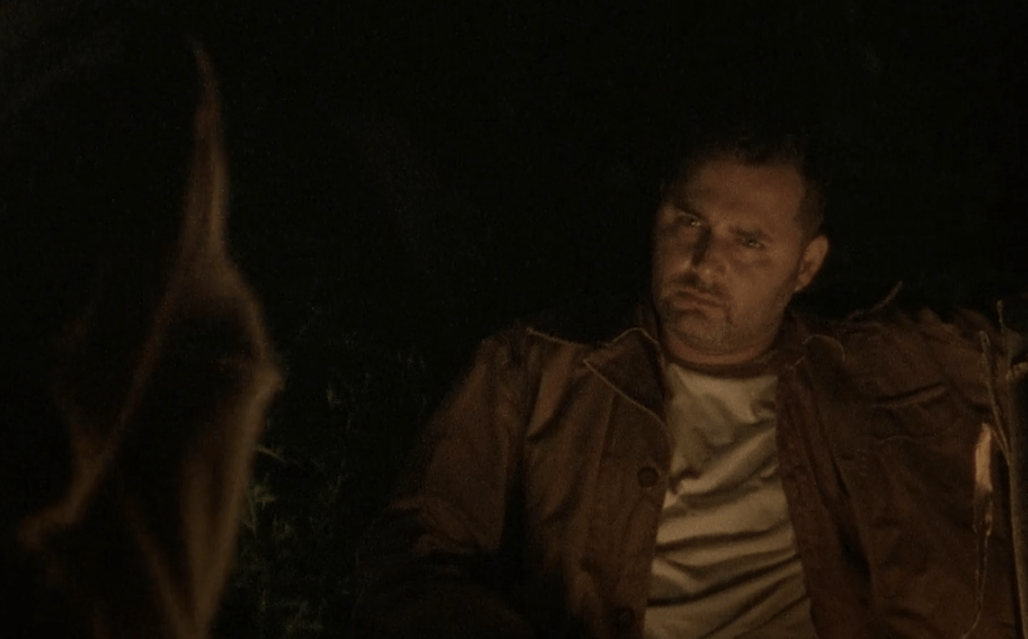 Ed sits by the fire in a scene from 'The Walking Dead' episode 'Tell It To the Frogs'