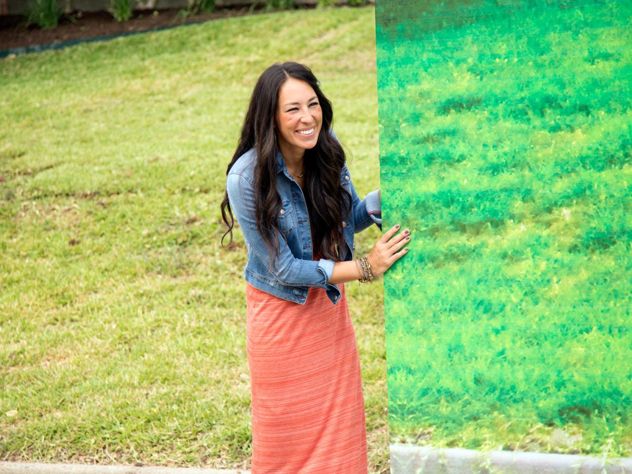 Joanna Gaines holds a canvas in a scene from Fixer Upper