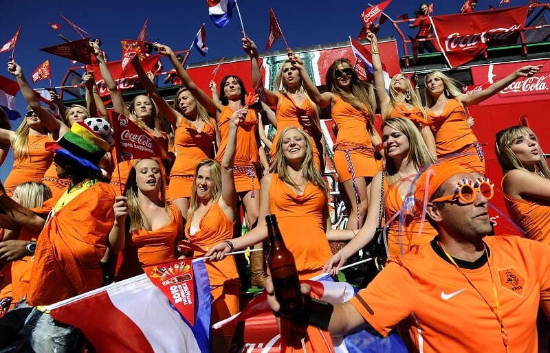 Dutch fans all dressed in orange cheer on their national team. 