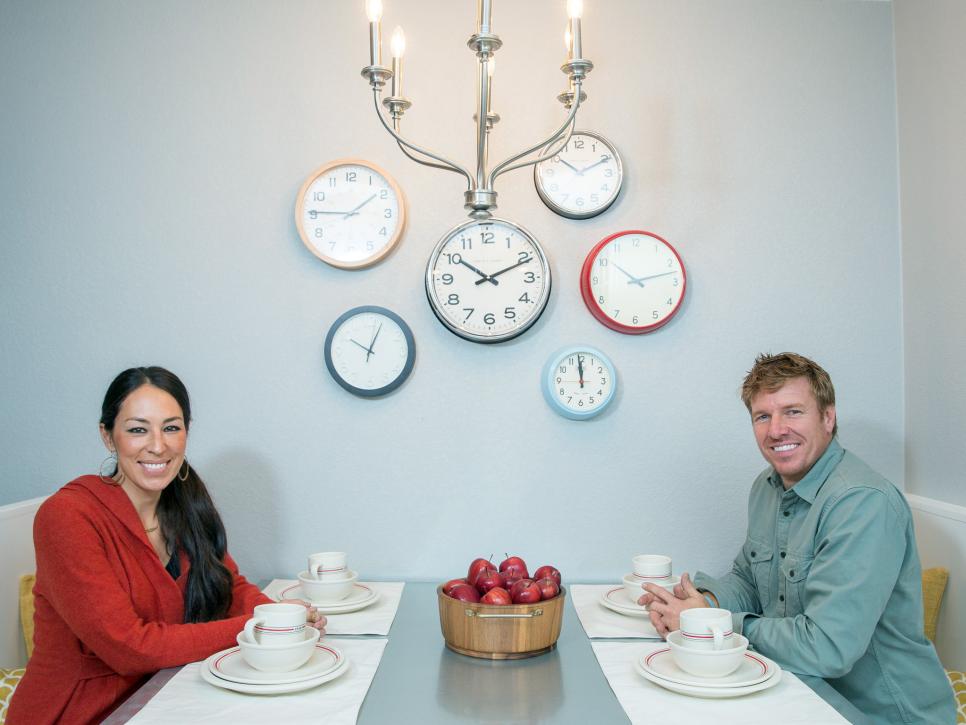 Fixer Upper hosts Chip and Joanna Gaines sit in the new kitchen built-in in the Silva home.