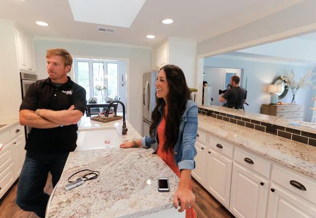 Chip and Joanna Gaines stand at a kitchen island on Season 4 of HGTV's Fixer Upper