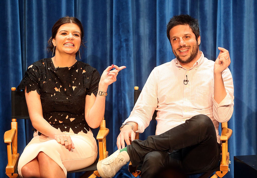 Casey Wilson and David Caspe laughing together, while speaking at a panel together in 2014