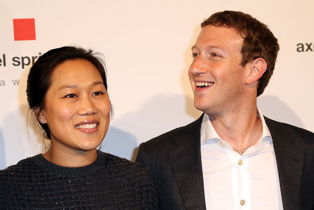 Priscilla Chan and Mark Zuckerberg smiling for the camera on the red carpet