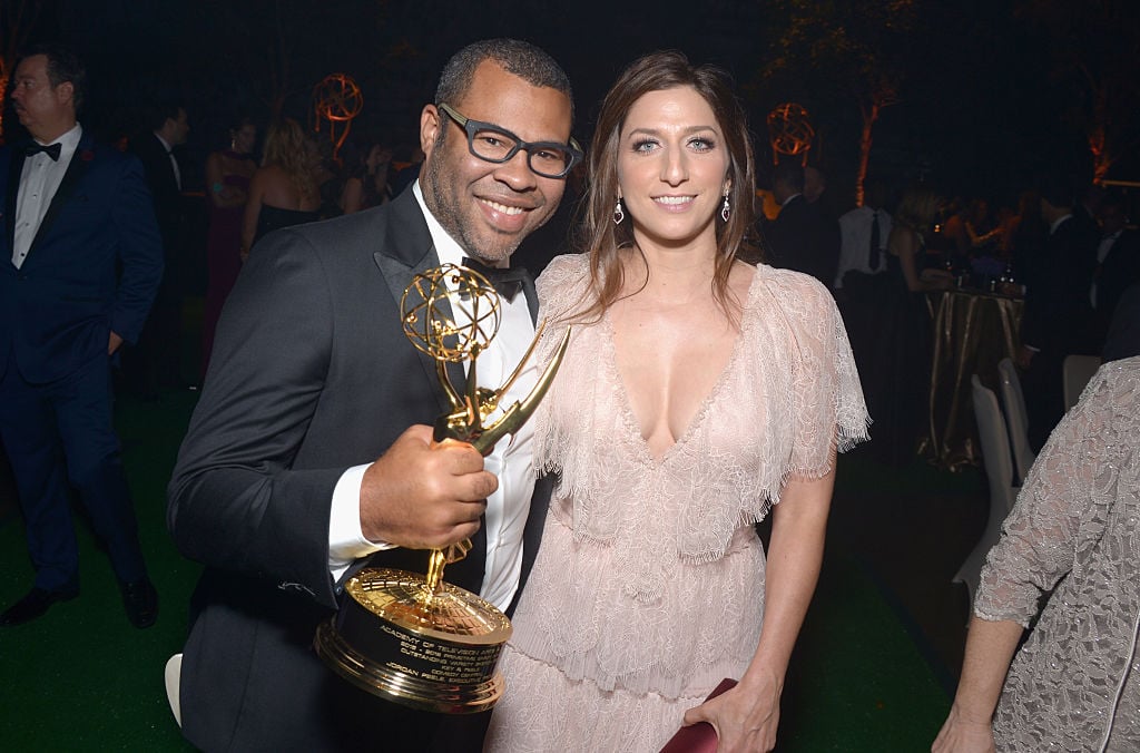 Jordan Peele with an Emmy in hand, standing next to Chelsea Peretti