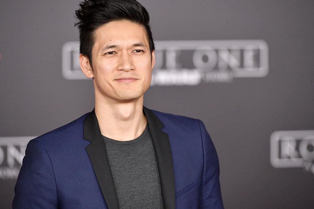 Harry Shum Jr. smiling on the red carpet at the world premiere of Rogue One