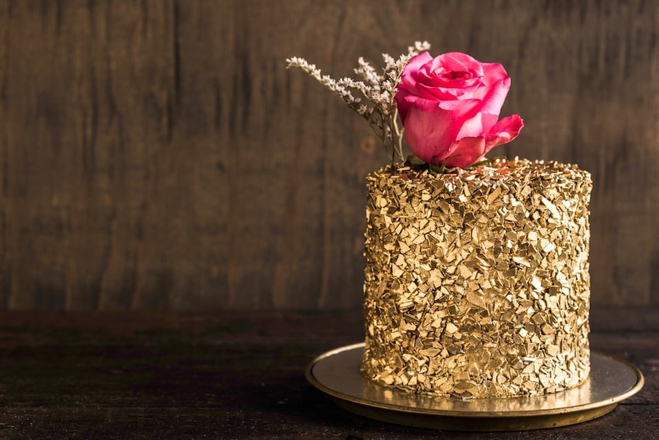 Golden chocolate cake on wooden background
