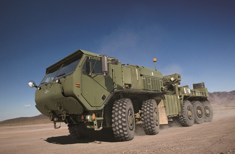 An LVSR Wrecker kicking up dust as it drives.