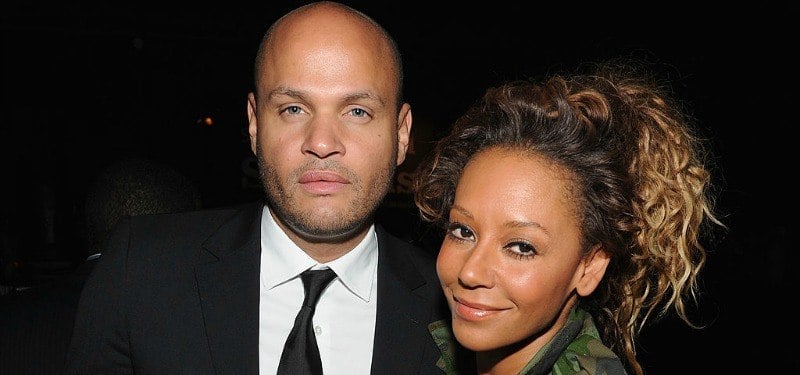 Stephen Belafonte looks seriously at the camera as Mel B smiles.