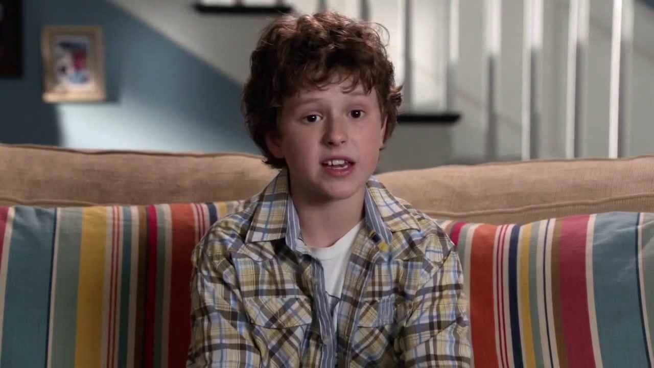Nolan Gould, speaking directly to the camera and sitting on a couch