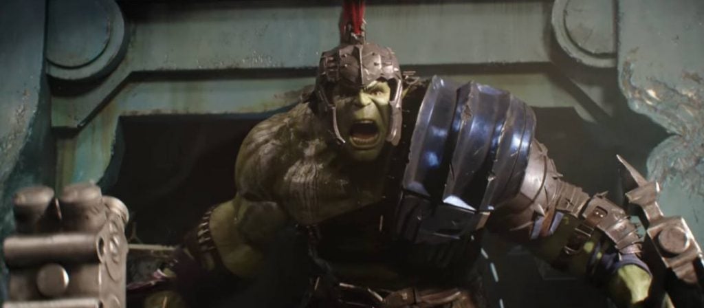 The Hulk holding weapons in either hand, yelling and wearing gladiator armor