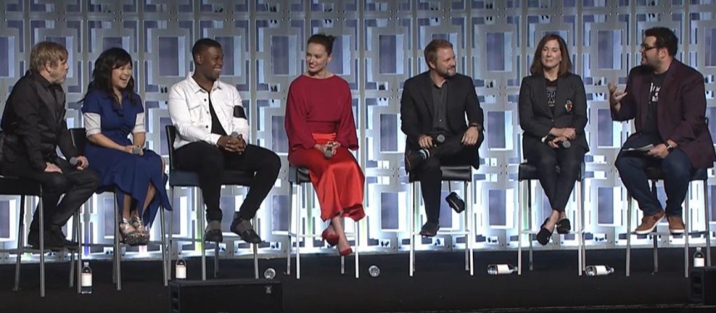 The cast of Star Wars: The Last Jedi, sitting on stools at a Celebration panel