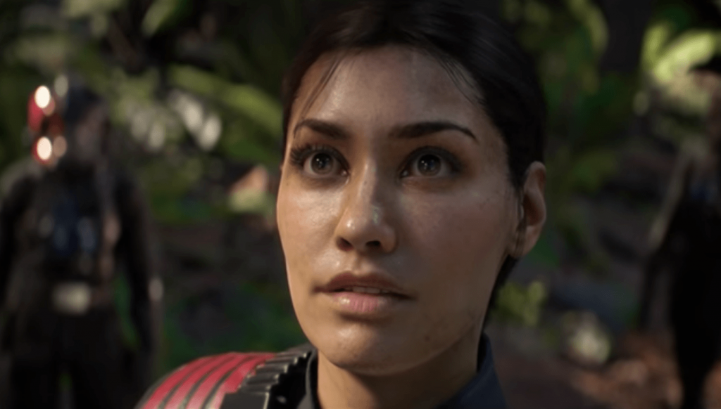 A close-up of Iden Versio, glancing upwards in the frame