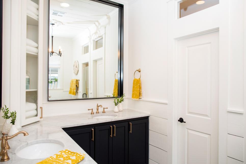 This master bath features a simple color palette with a touch of yellow for a colorful pop, as seen on Fixer Upper.