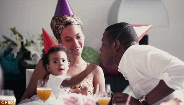 Blue Ivy, Beyoncé and Jay Z wear party hats as they celebrate a birthday in 'Lemonade.'