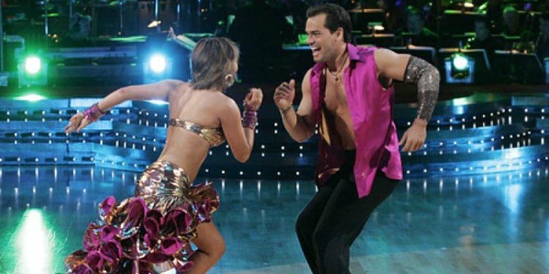 Cristian de La Fuente and Cheryl Burke are looking at each other while dancing.