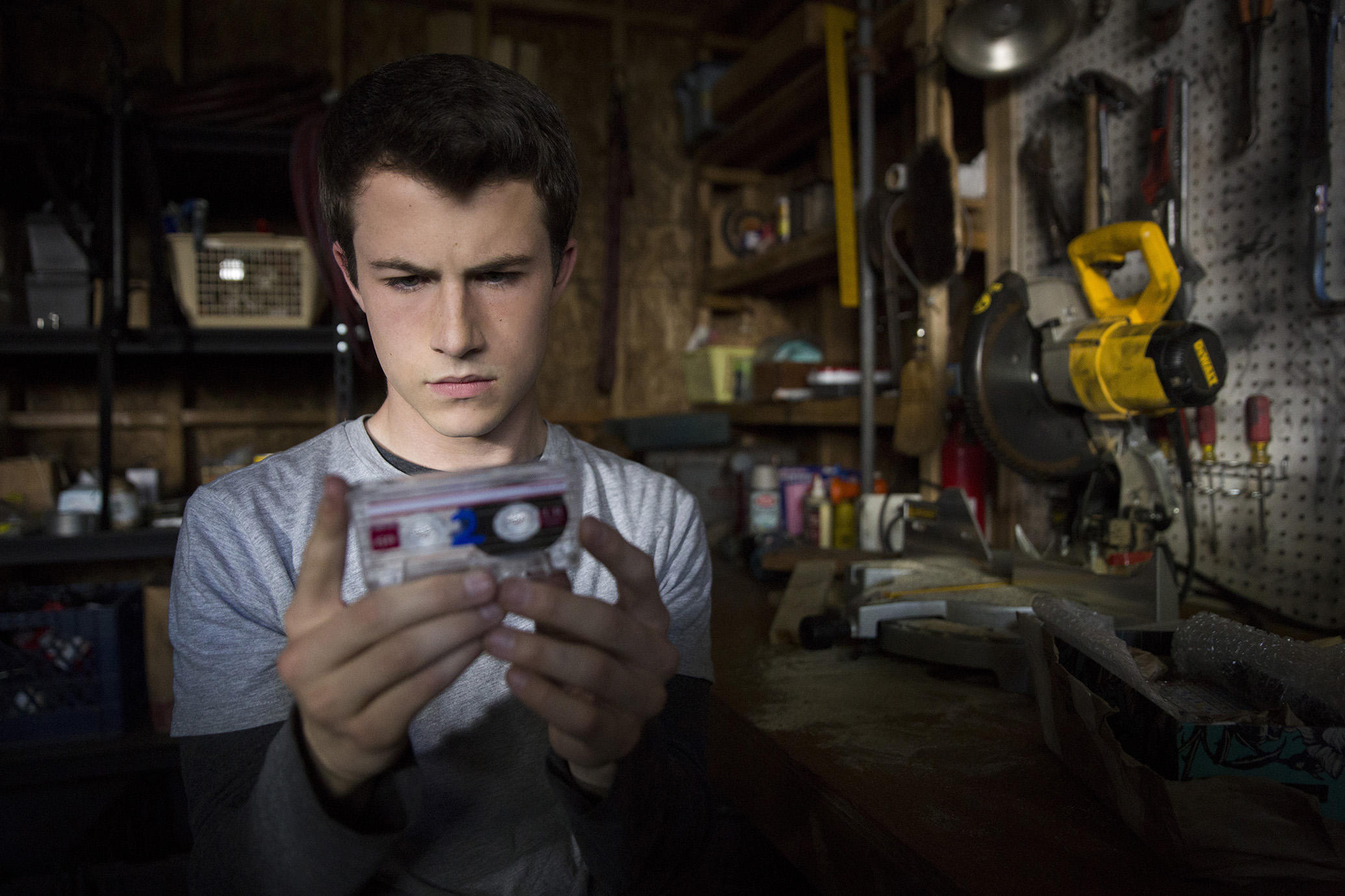 Clay Jensen stares at a cassette tape in a scene from '13 Reasons Why.'