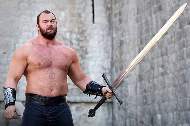 The Mountain, a.k.a. Gregor Clegane, stands, shirtless, and brandishes a long sword in a scene from 'Game of Thrones.'